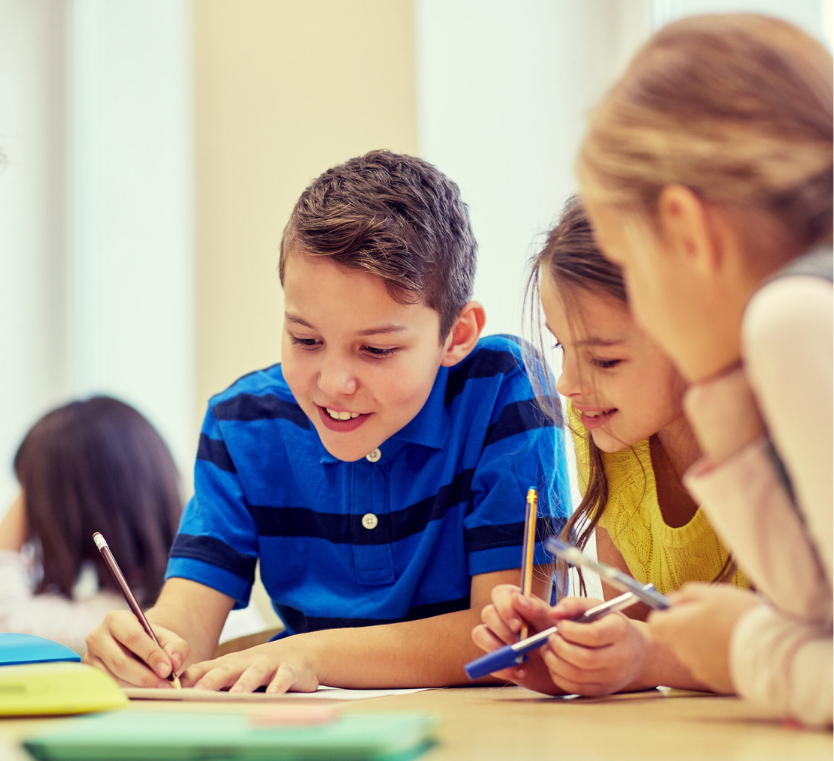 group of students talking and writing at school